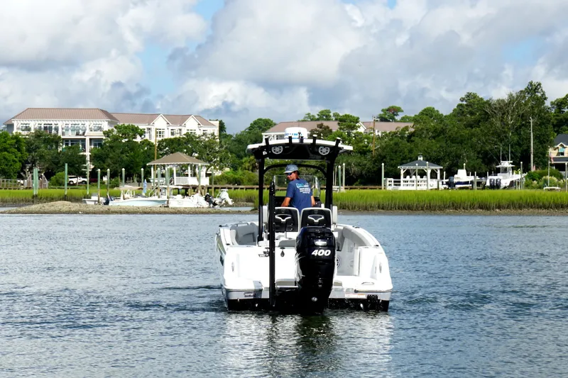 Slide: The Image of 2022 Wellcraft 242 Scarab Offshore boat cruising on a scenic waterway. - 1