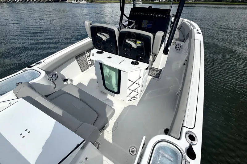 Slide: The Image of 2022 Wellcraft 242 Scarab Offshore boat interior with seating and control panel on water. - 9