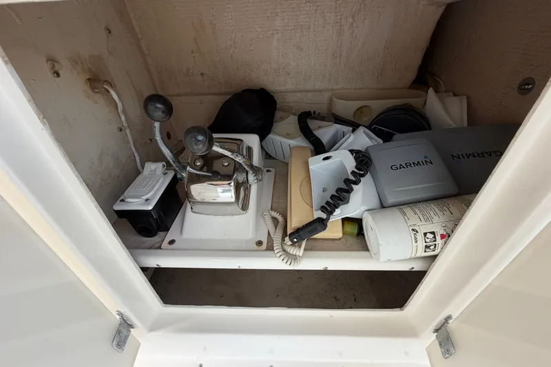 Slide: The Image of Storage compartment in a 1996 Post 46 Convertible boat with navigation equipment and controls. - 13