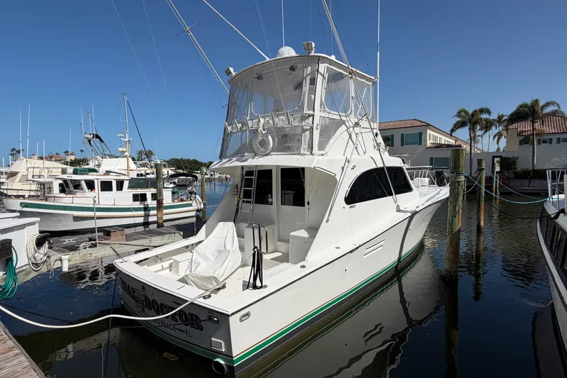 Slide: The Image of 1996 Post 46 Convertible yacht docked at marina under clear blue sky. - 3