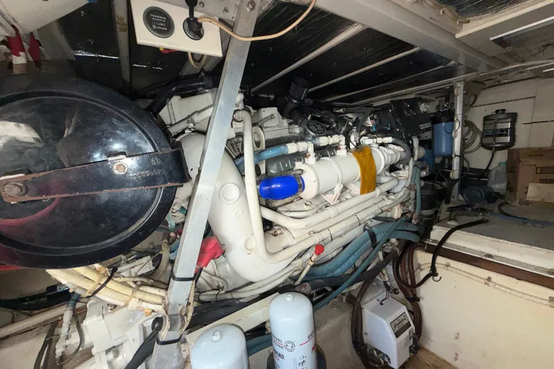 Slide: The Image of Engine room of a 1996 Post 46 Convertible boat, showcasing complex machinery and components. - 28