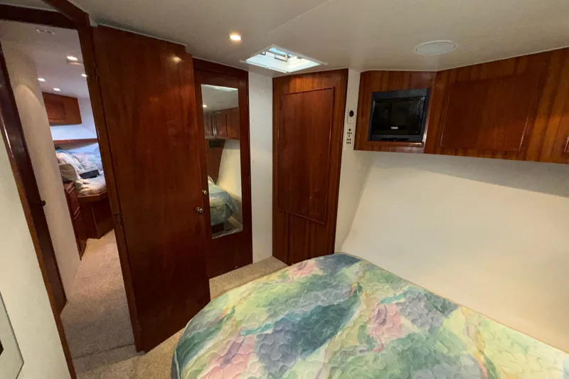 Slide: The Image of Interior of 1996 Post 46 Convertible yacht with wood paneling and cozy bedroom. - 22