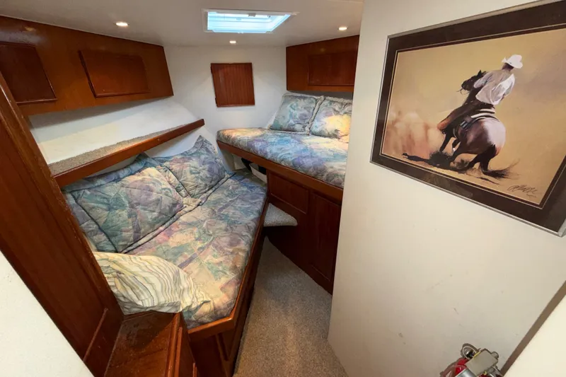 Slide: The Image of 1996 Post 46 Convertible yacht cabin with twin beds and equestrian artwork. - 25