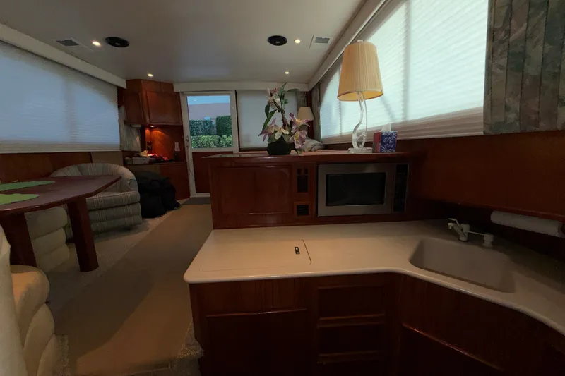 Slide: The Image of Interior of a 1996 Post 46 Convertible yacht with kitchen and seating area. - 18