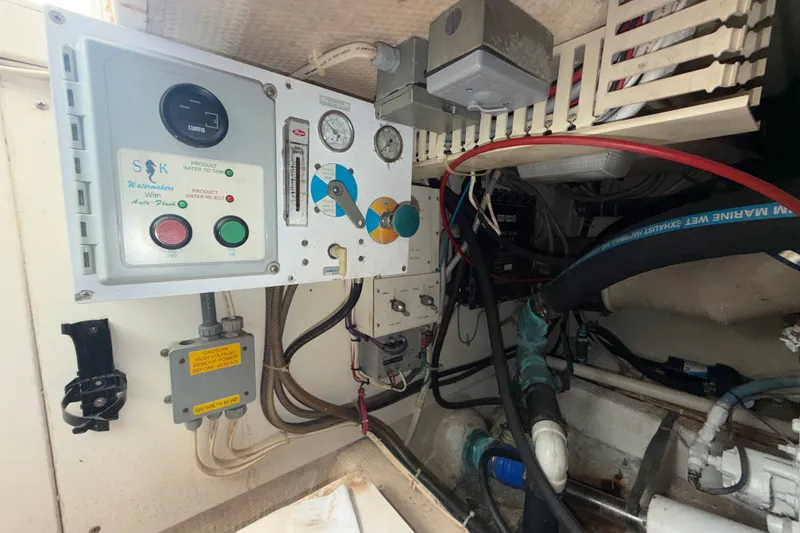 Slide: The Image of Engine room of a 1996 Post 46 Convertible with watermaker control panel and gauges. - 34