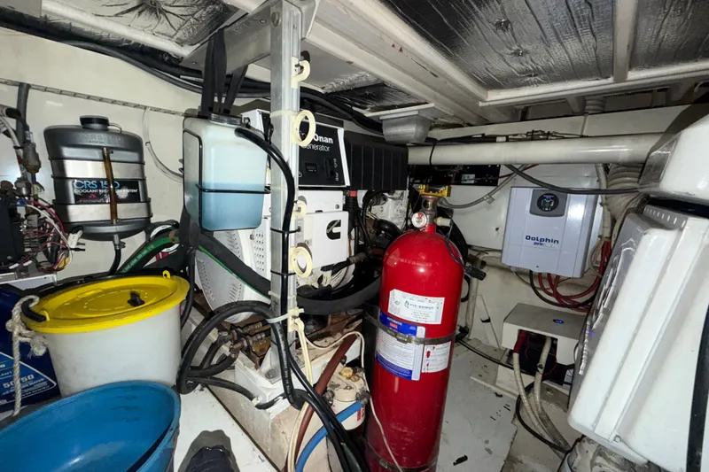 Slide: The Image of Engine room of a 1996 Post 46 Convertible boat with generator and fire extinguisher. - 32
