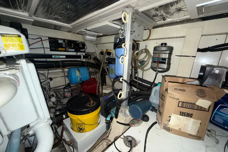 Slide: The Image of Engine room of a 1996 Post 46 Convertible boat with various equipment and storage items. - 31