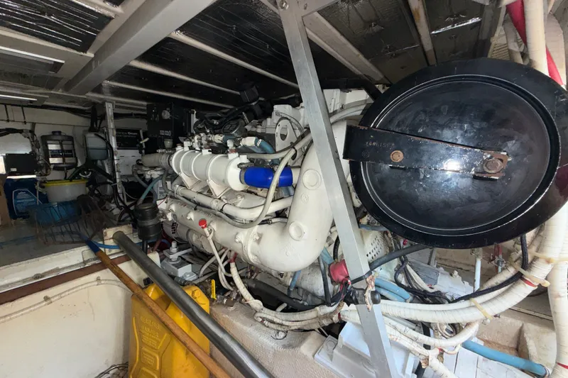 Slide: The Image of Engine room of a 1996 Post 46 Convertible boat, showcasing mechanical components and wiring. - 29
