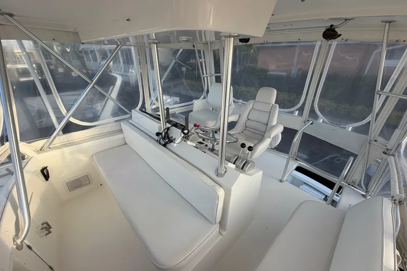 Slide: The Image of Interior of a 1996 Post 46 Convertible yacht with white seating and helm. - 10