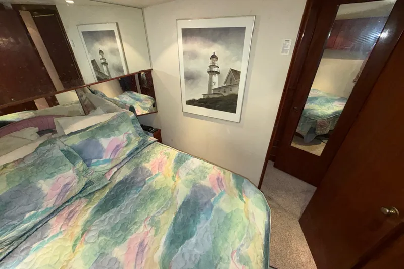 Slide: The Image of Bedroom interior of 1996 Post 46 Convertible with colorful bedding and lighthouse artwork. - 21
