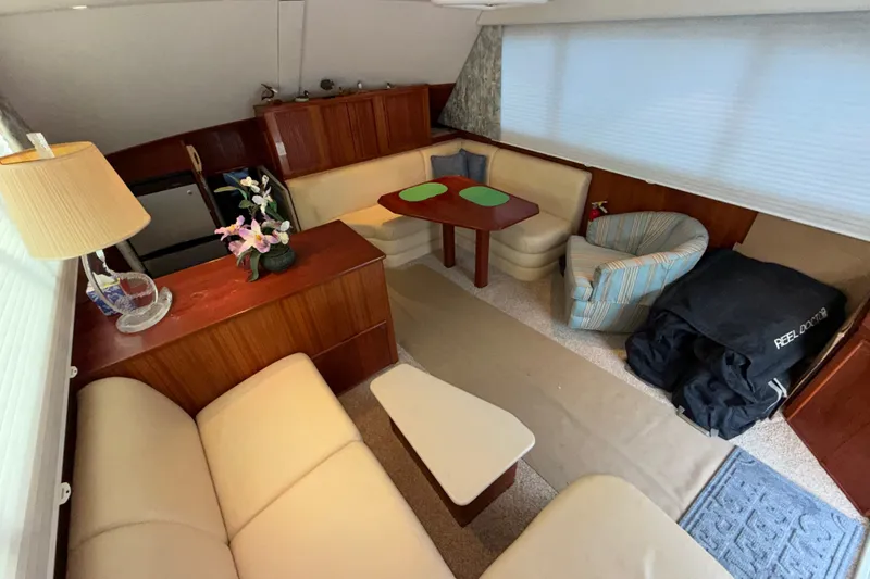 Slide: The Image of Interior of a 1996 Post 46 Convertible yacht with cozy seating and elegant decor. - 15