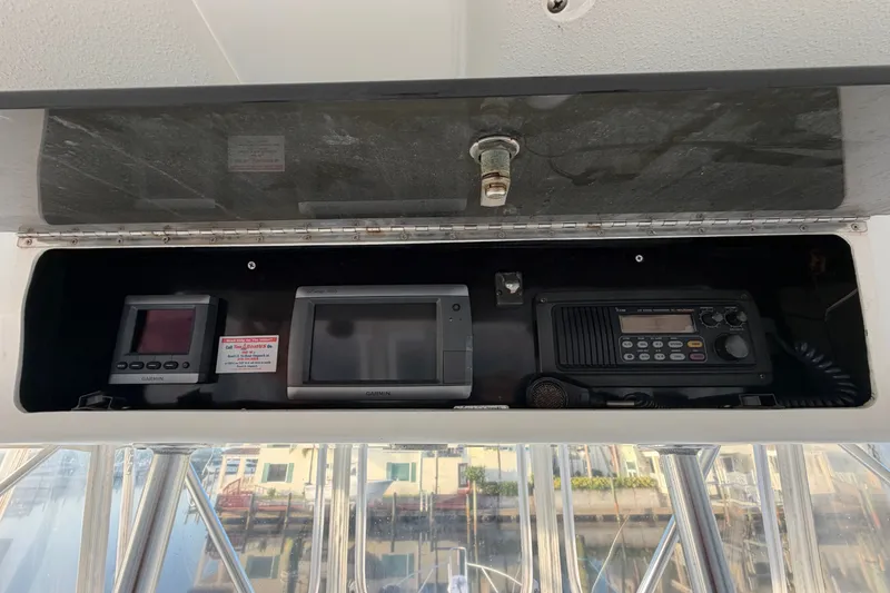 Slide: The Image of Electronics panel on a 1996 Post 46 Convertible boat, featuring Garmin devices and radio equipment. - 12