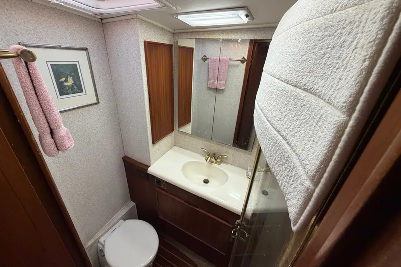 Slide: The Image of Bathroom interior of 1996 Post 46 Convertible yacht with sink, mirror, and toilet. - 26