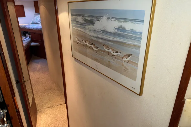 Slide: The Image of Hallway in 1996 Post 46 Convertible yacht with beach-themed artwork on wall. - 24