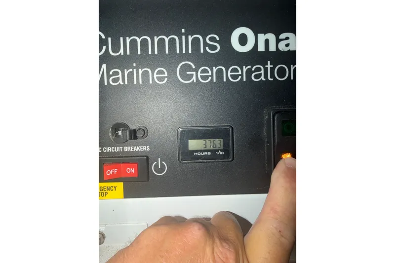 Slide: The Image of Cummins Onan marine generator control panel with 3763 hours displayed, 1996 Post 46 Convertible. - 33
