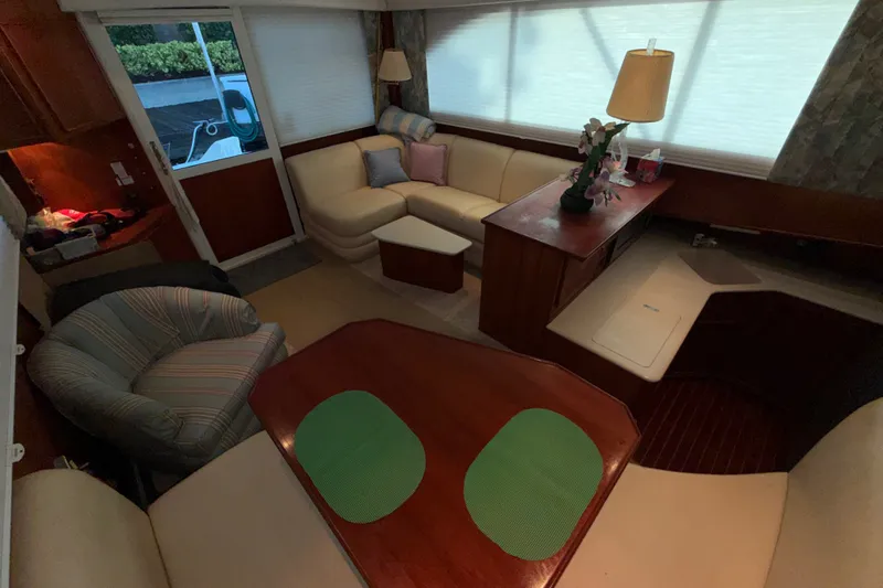 Slide: The Image of Interior of a 1996 Post 46 Convertible yacht with cozy seating and elegant decor. - 16