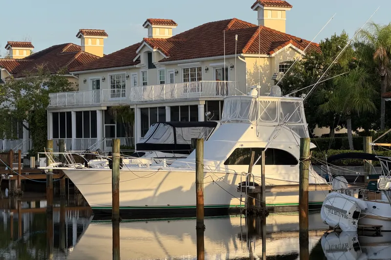 The Image of Luxury yacht docked near waterfront homes, Post 46 Convertible, 1996 model. - 0