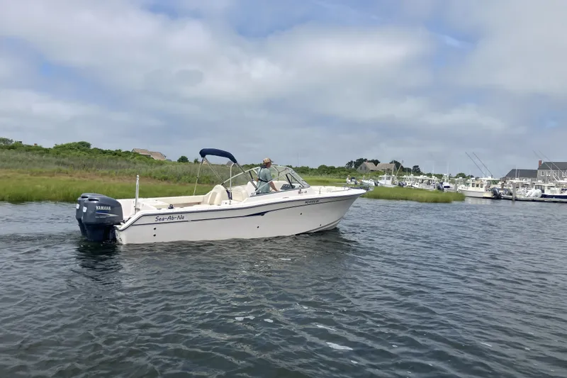 Slide: The Image of 2008 Grady White 275 Tournament boat cruising on a calm waterway under a cloudy sky. - 5