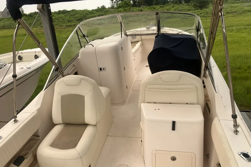 Slide: The Image of 2008 Grady White 275 Tournament boat interior with seating and console, parked on grass. - 30