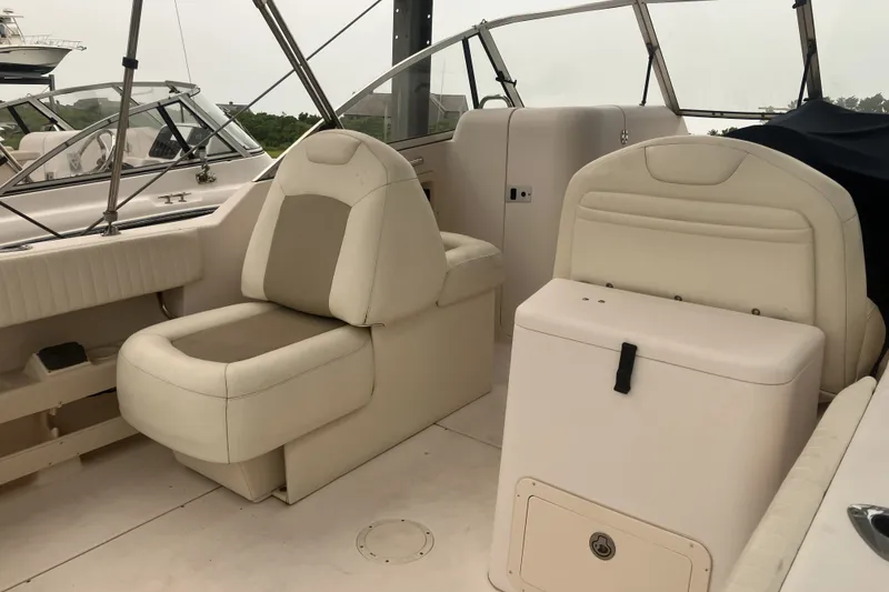 Slide: The Image of 2008 Grady White 275 Tournament boat interior with beige seating and storage. - 13