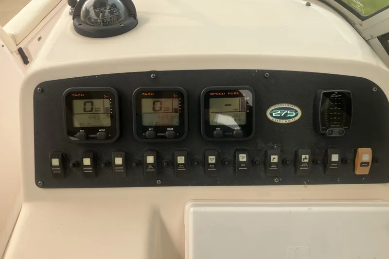 Slide: The Image of Dashboard of a 2008 Grady White 275 Tournament boat with gauges and controls. - 20