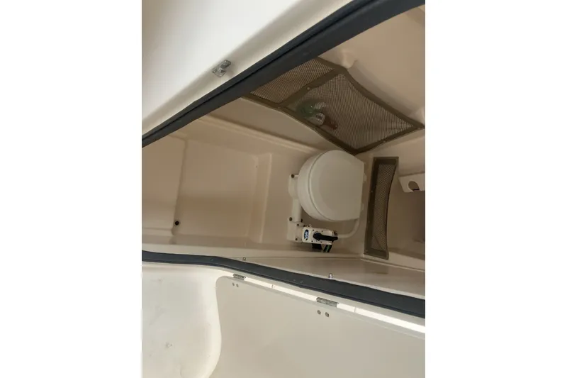 Slide: The Image of Interior view of a 2008 Grady White 275 Tournament boat's compact bathroom area. - 36