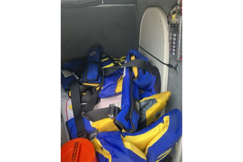 Slide: The Image of Life jackets and safety equipment stored on a 2008 Grady White 275 Tournament boat. - 18