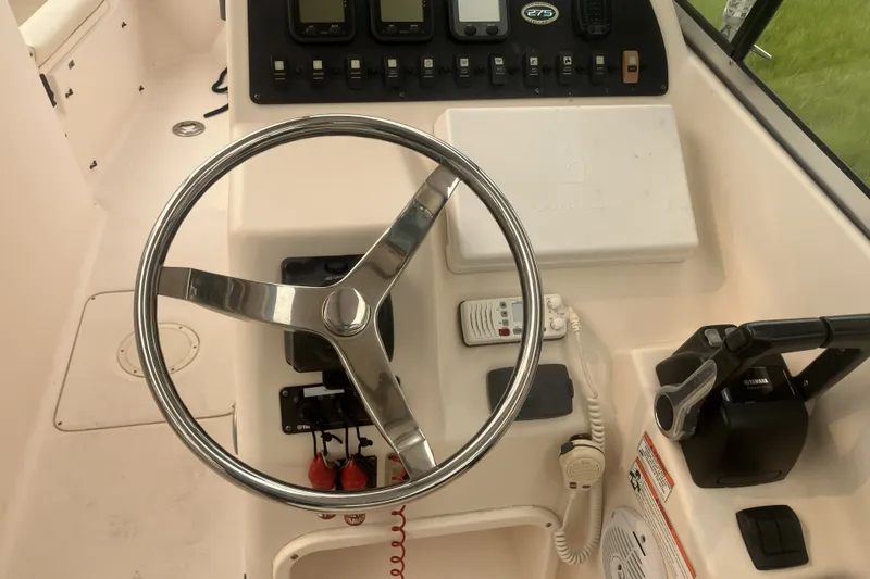 Slide: The Image of Steering console of a 2008 Grady White 275 Tournament boat with controls and instruments. - 16