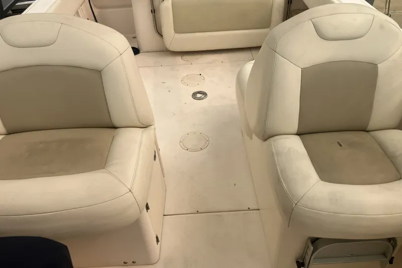 Slide: The Image of 2008 Grady White 275 Tournament boat interior with beige seating and clean deck. - 12