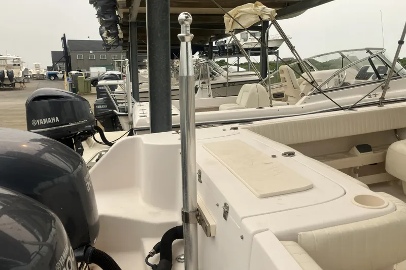Slide: The Image of 2008 Grady White 275 Tournament boat with Yamaha engines in a marina setting. - 29
