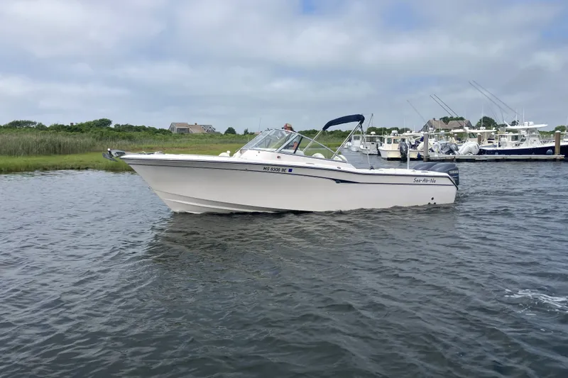 Slide: The Image of 2008 Grady White 275 Tournament boat on calm water near marina. - 2