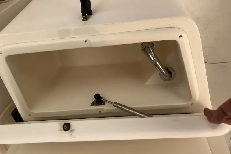 Slide: The Image of Storage compartment on a 2008 Grady White 275 Tournament boat, featuring a handle and latch. - 24