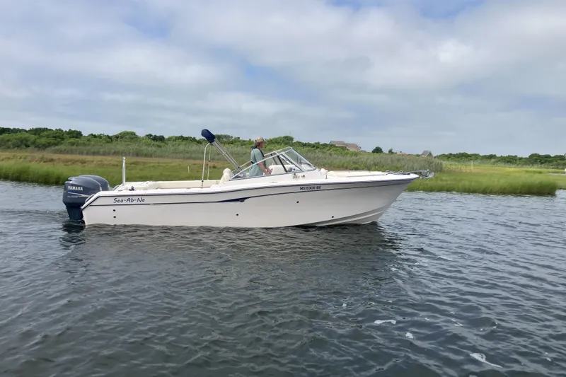 The Image of 2008 Grady White 275 Tournament boat cruising on a calm river with lush green banks. - 1
