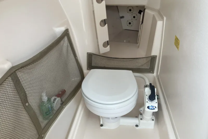 Slide: The Image of 2008 Grady White 275 Tournament boat interior with marine toilet and storage compartments. - 17