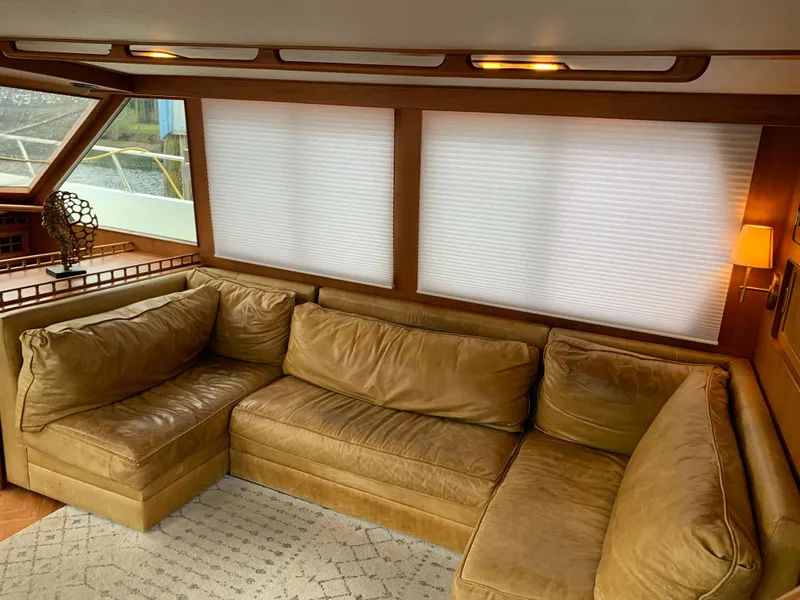 Slide: The Image of 1991 TransWorld Cockpit Motoryacht interior with leather sectional sofa and large windows. - 22