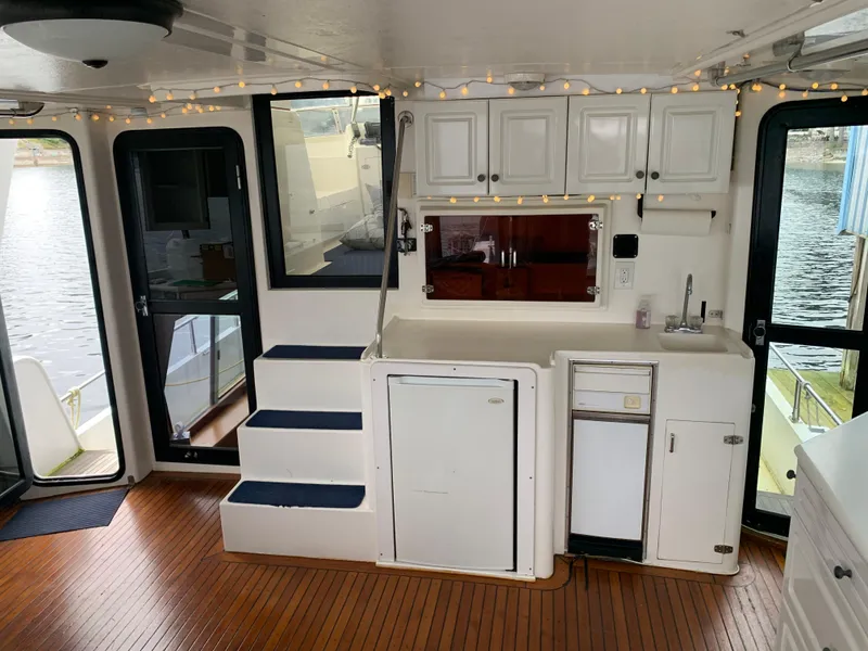 Slide: The Image of Interior of 1991 TransWorld Cockpit Motoryacht with kitchenette and wooden flooring. - 25