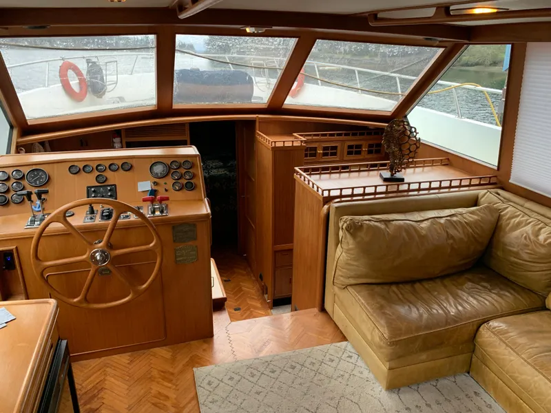 Slide: The Image of 1991 TransWorld Cockpit Motoryacht interior with helm, gauges, and leather seating. - 23