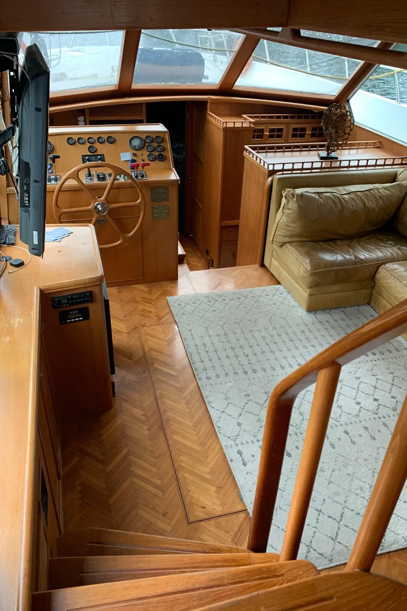 Slide: The Image of 1991 TransWorld Cockpit Motoryacht interior with helm, seating area, and wooden flooring. - 35