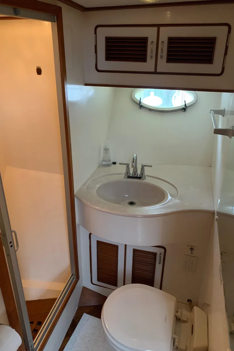 Slide: The Image of 1991 TransWorld Cockpit Motoryacht bathroom with sink, toilet, and shower. - 21