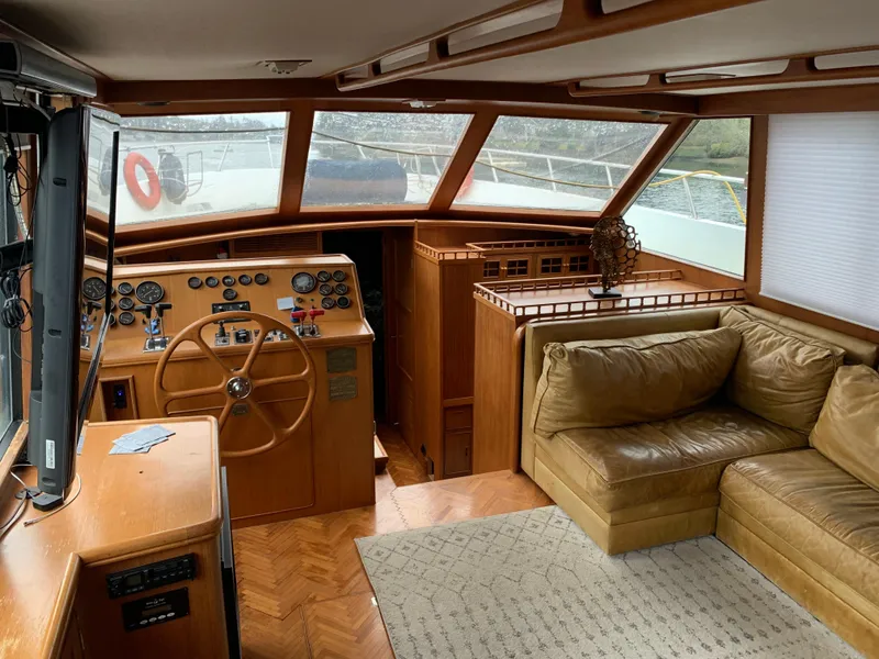 Slide: The Image of 1991 TransWorld Cockpit Motoryacht interior with helm, gauges, and leather seating. - 16