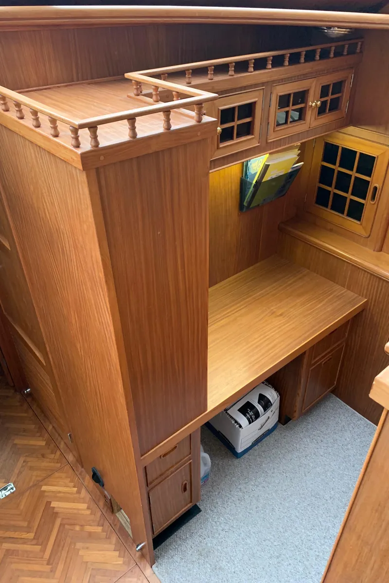 Slide: The Image of 1991 TransWorld Cockpit Motoryacht interior with wooden cabinetry and desk area. - 31
