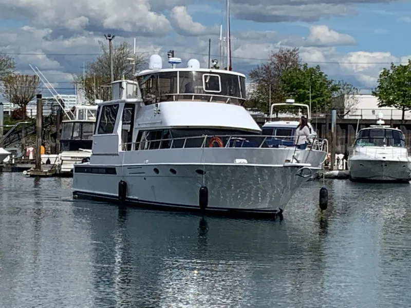 The Image of 1991 TransWorld Cockpit Motoryacht docked in a marina on a sunny day. - 1