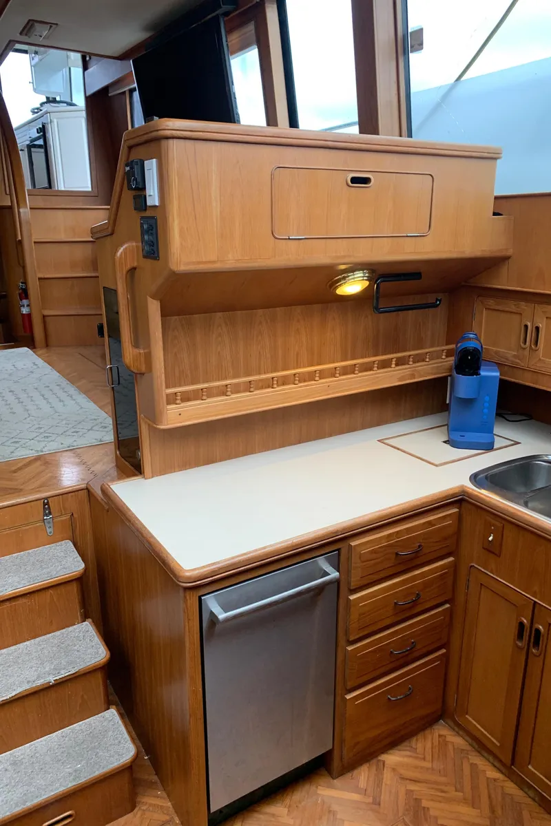 Slide: The Image of 1991 TransWorld Cockpit Motoryacht kitchen with wooden cabinetry and modern appliances. - 33