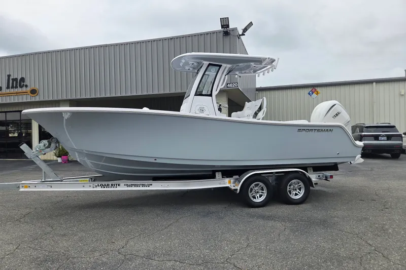 The Image of 2026 Sportsman Open 232 Center Console boat on trailer outside dealership. - 0