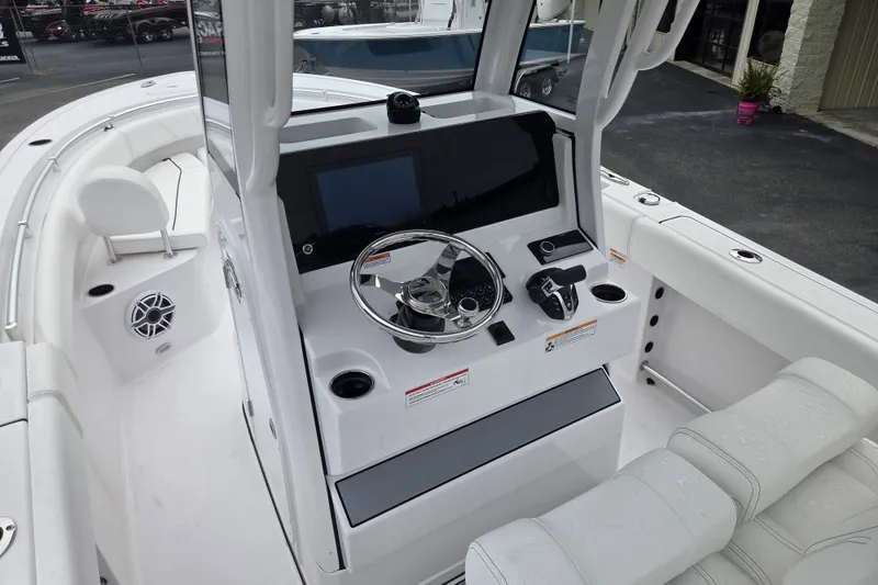 Slide: The Image of 2026 Sportsman Open 232 Center Console boat interior with steering wheel and control panel. - 11