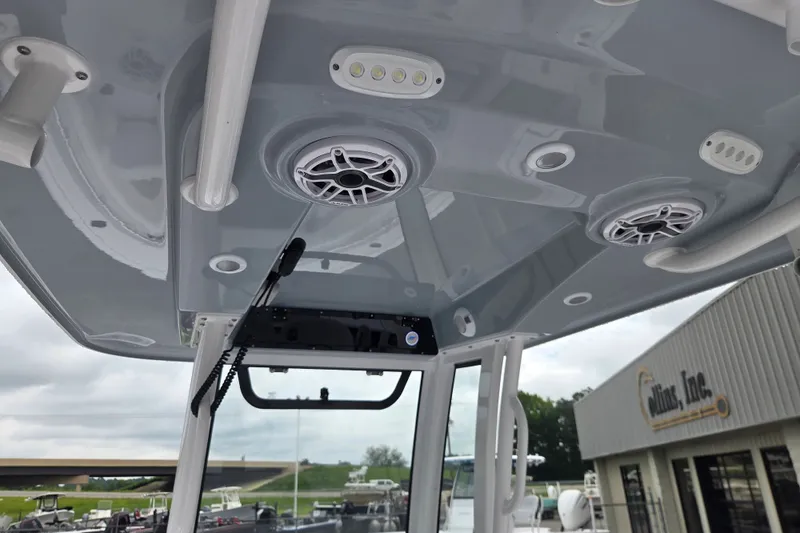 Slide: The Image of 2026 Sportsman Open 232 Center Console boat interior with speakers and lighting fixtures. - 9