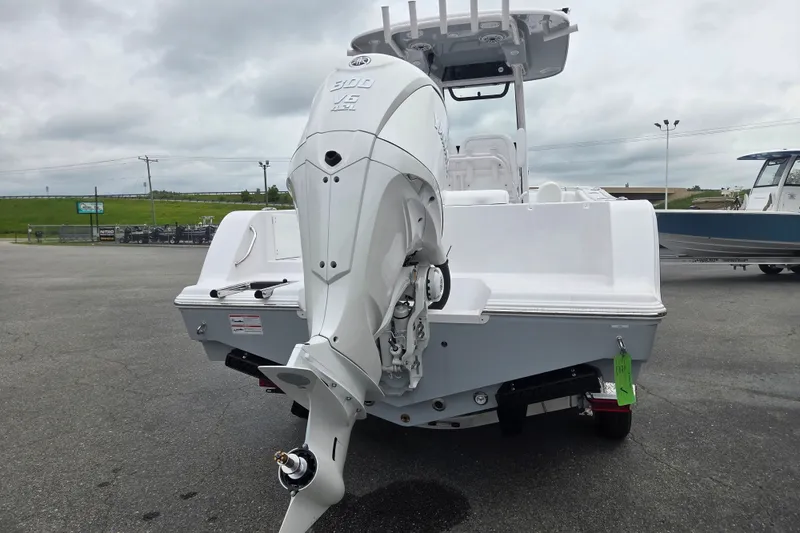 Slide: The Image of 2026 Sportsman Open 232 Center Console boat with powerful outboard motor, parked outdoors. - 3