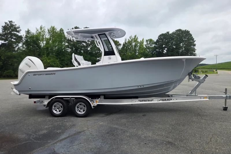 Slide: The Image of 2026 Sportsman Open 232 Center Console boat on trailer, parked outdoors. - 5