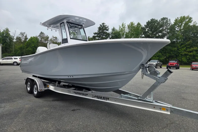Slide: The Image of 2026 Sportsman Open 232 Center Console boat on trailer in parking lot. - 6
