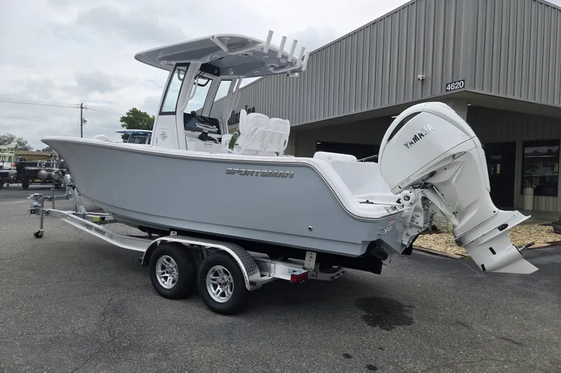 Slide: The Image of 2026 Sportsman Open 232 Center Console boat with Yamaha engine on trailer. - 2